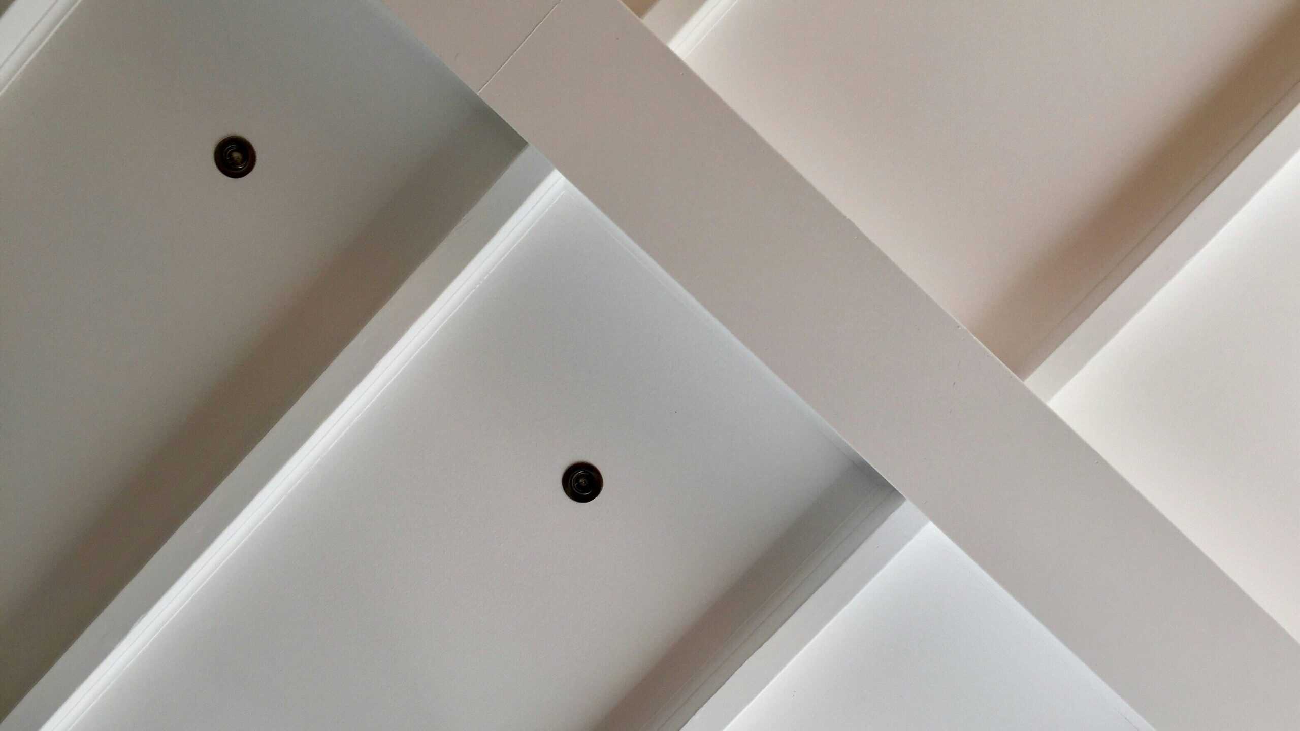 Coffered ceiling with recessed light fixtures in a clean white finish, viewed from below