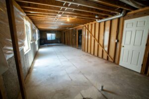 Secure basement with framing and insulation for structural repair and waterproofing solutions.
