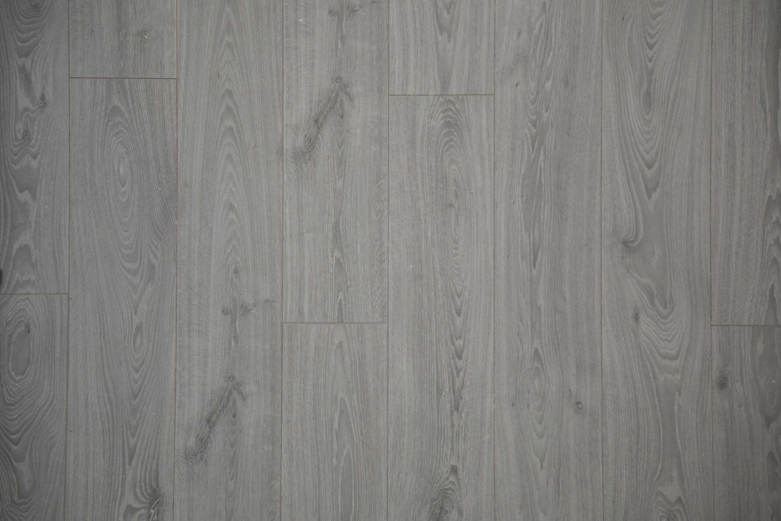 Close-up view of gray laminate flooring with realistic wood grain texture